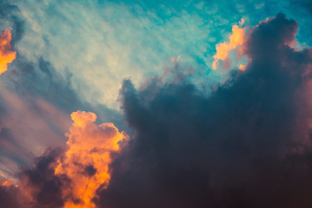 clouds in sunset colored sky of orange and blue